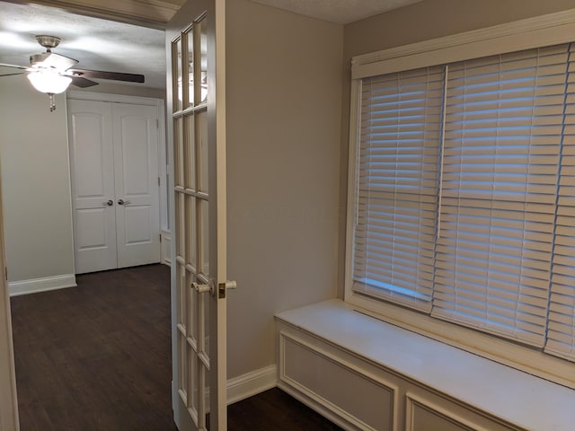 hallway featuring a textured ceiling and dark hardwood / wood-style flooring