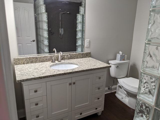 bathroom with vanity, hardwood / wood-style floors, and toilet