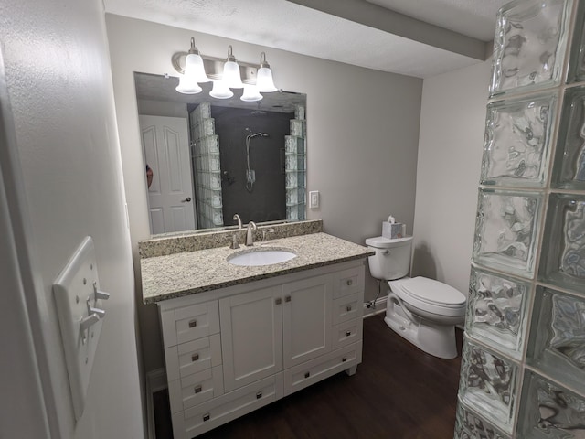 bathroom with vanity, wood-type flooring, and toilet