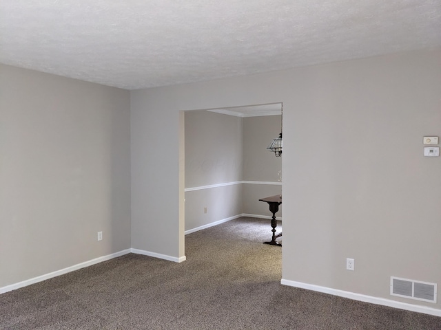 empty room featuring carpet floors and a textured ceiling