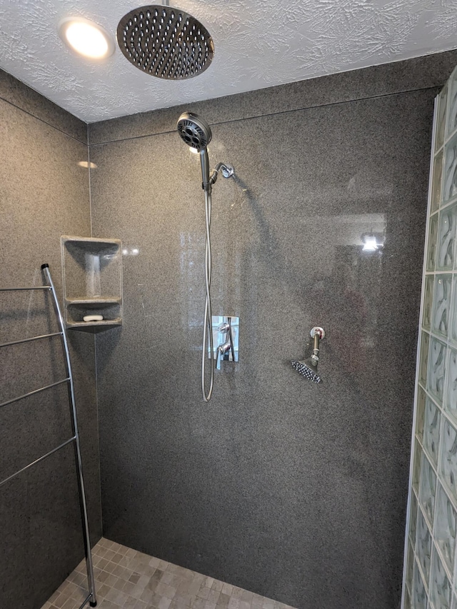 details with tiled shower and a textured ceiling