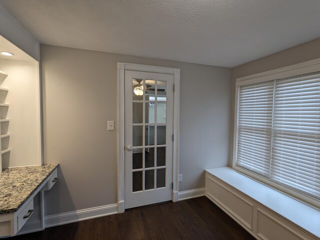 interior space with dark wood-type flooring and a textured ceiling