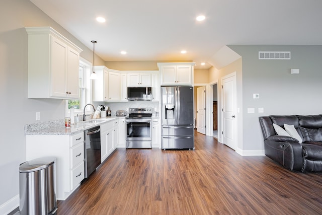 kitchen featuring appliances with stainless steel finishes, dark hardwood / wood-style flooring, white cabinetry, and hanging light fixtures