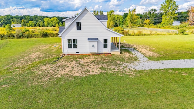 back of house with a lawn