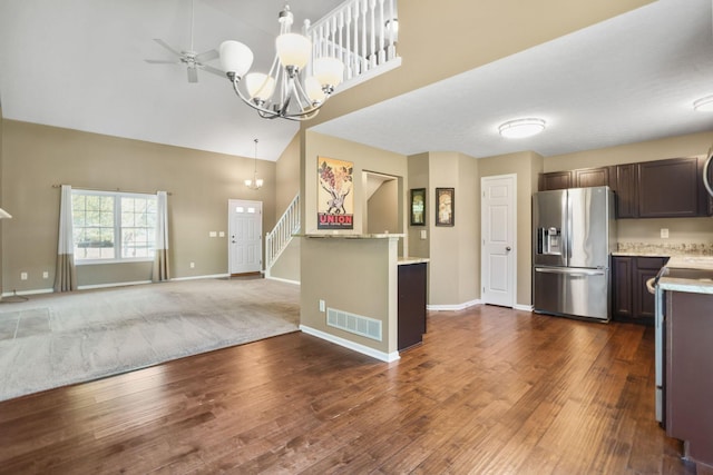 kitchen featuring pendant lighting, high vaulted ceiling, dark hardwood / wood-style floors, appliances with stainless steel finishes, and dark brown cabinets