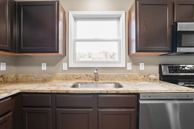 kitchen featuring dark brown cabinetry, stainless steel appliances, and sink