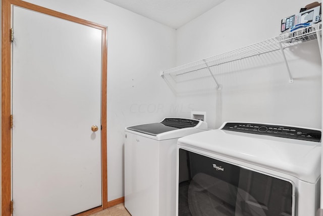 clothes washing area featuring washing machine and clothes dryer