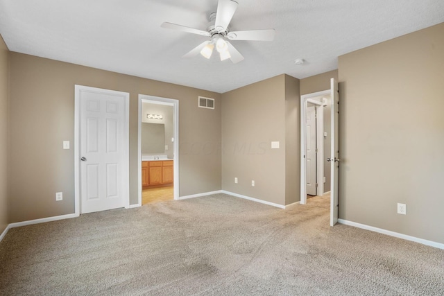 unfurnished bedroom featuring connected bathroom, ceiling fan, and light colored carpet