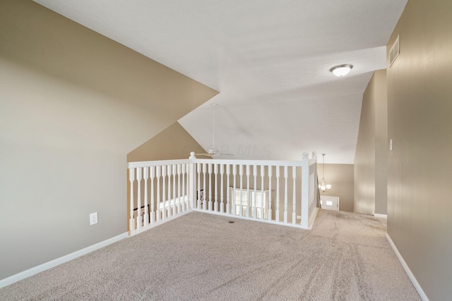 additional living space featuring carpet, vaulted ceiling, and ceiling fan