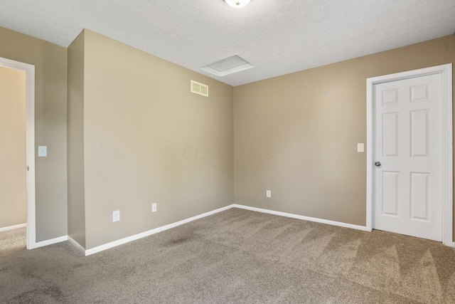 empty room featuring carpet flooring and a textured ceiling