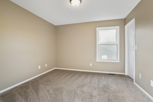 spare room featuring carpet flooring