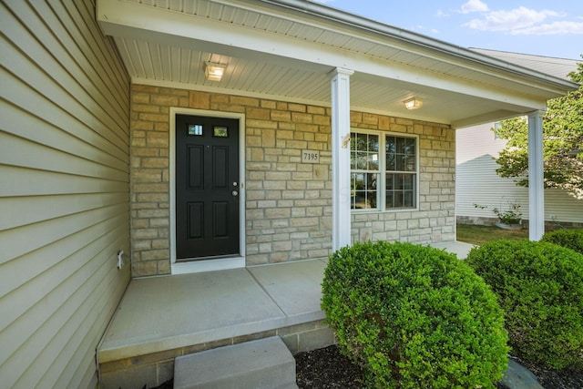 view of exterior entry featuring a porch