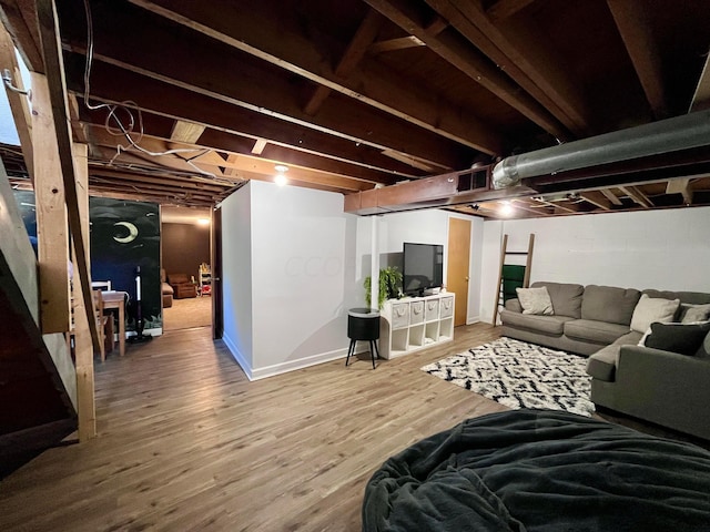 basement with hardwood / wood-style floors