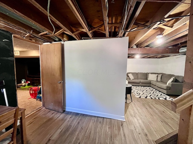 basement featuring hardwood / wood-style floors