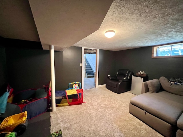 rec room with a textured ceiling and carpet floors