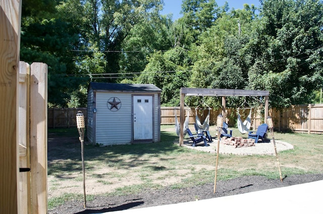 view of yard featuring a shed and a fire pit