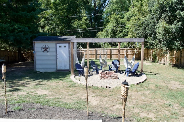 view of yard with a storage unit and an outdoor fire pit