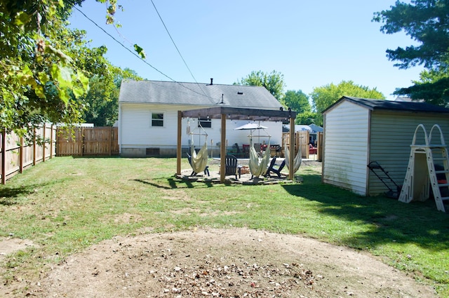 rear view of property with a shed and a yard