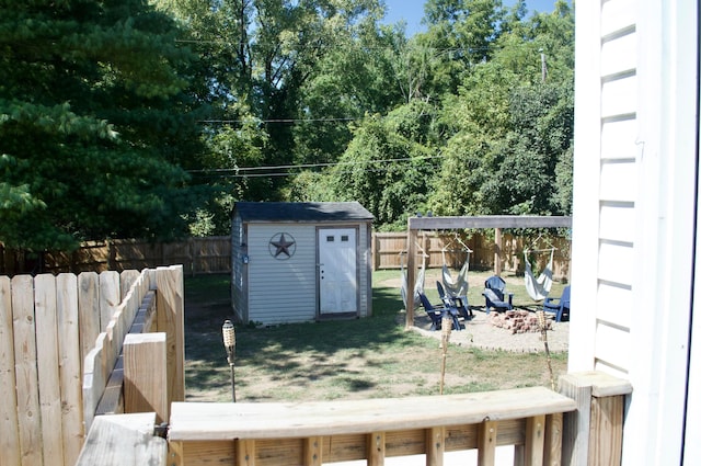 view of yard with a storage shed and an outdoor fire pit