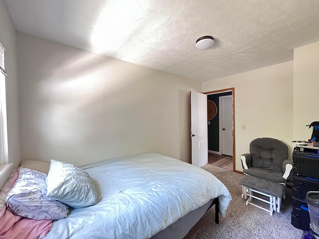 carpeted bedroom featuring a textured ceiling