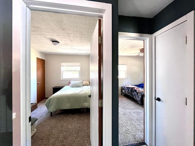 carpeted bedroom featuring a textured ceiling