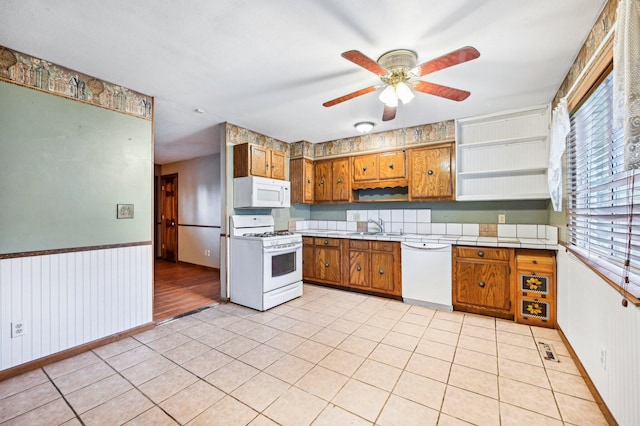 5010 Chipman Dr, Columbus, OH 43232 - kitchen with white appliances, brown cabinets, a ceiling fan, tile counters, and a sink