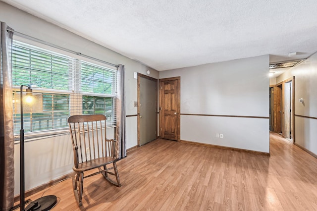 5010 Chipman Dr, Columbus, OH 43232 - sitting room with a textured ceiling, light wood-style flooring, and baseboards