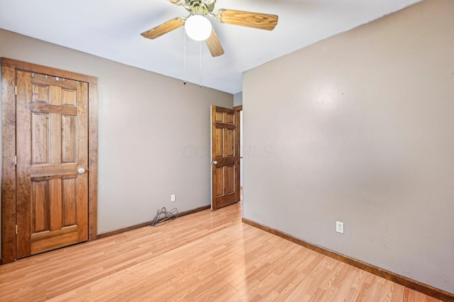 5010 Chipman Dr, Columbus, OH 43232 - unfurnished bedroom featuring light wood finished floors, baseboards, and a ceiling fan