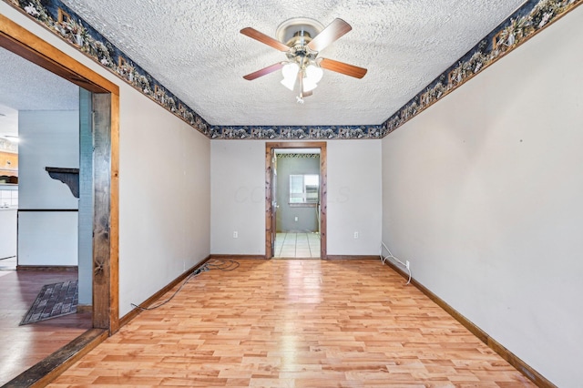 5010 Chipman Dr, Columbus, OH 43232 - unfurnished room with a textured ceiling, ceiling fan, wood finished floors, and baseboards