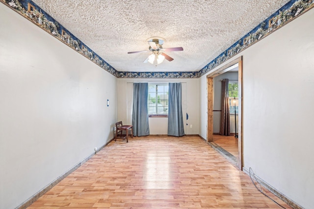 5010 Chipman Dr, Columbus, OH 43232 - spare room with light wood finished floors, ceiling fan, a textured ceiling, and baseboards