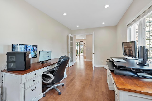 office space with recessed lighting, a wealth of natural light, french doors, and light wood-type flooring