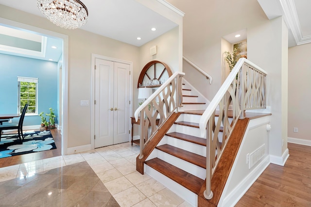 interior space featuring visible vents, an inviting chandelier, baseboards, stairway, and recessed lighting