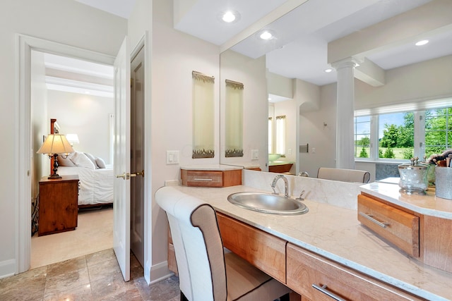 full bath featuring recessed lighting, decorative columns, ensuite bathroom, and vanity