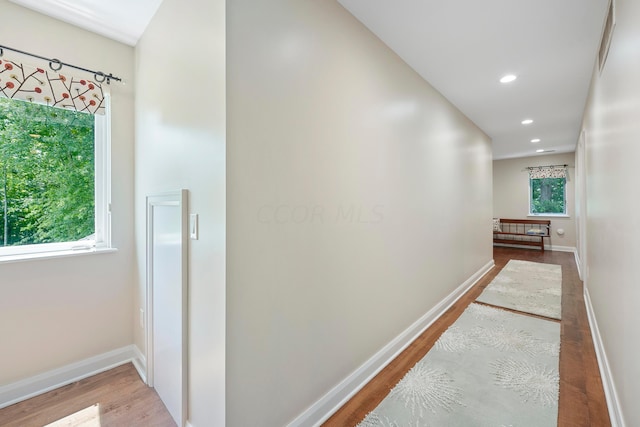 hallway with baseboards, recessed lighting, and wood finished floors