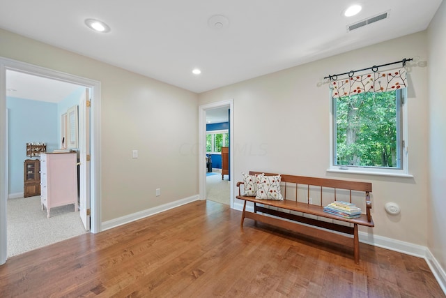 living area featuring visible vents, baseboards, and a wealth of natural light