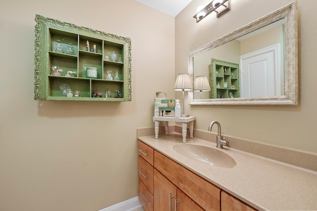 bathroom with baseboards and vanity