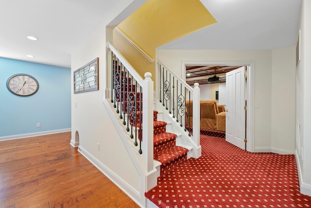 stairs with recessed lighting, baseboards, and wood finished floors
