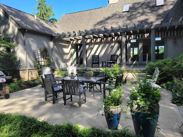 view of patio with area for grilling, a pergola, and outdoor dining area