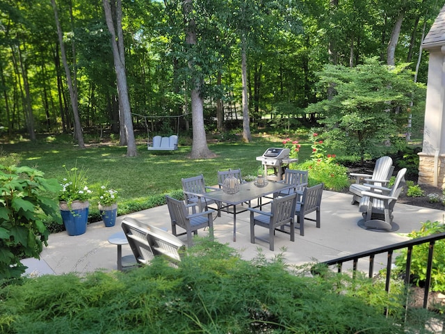view of patio with outdoor dining area and area for grilling