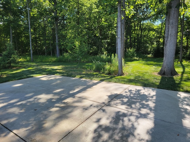 view of patio / terrace featuring a view of trees