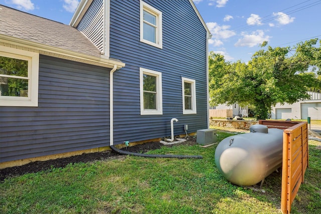 view of home's exterior featuring a yard and central AC