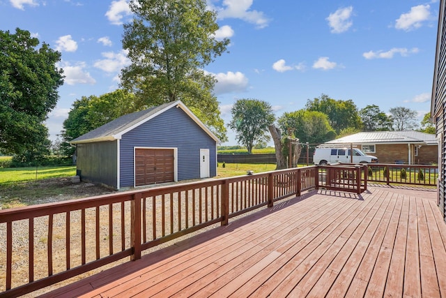 wooden terrace with a garage and an outbuilding