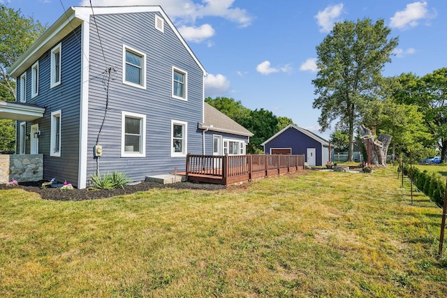 back of property featuring a yard and a deck