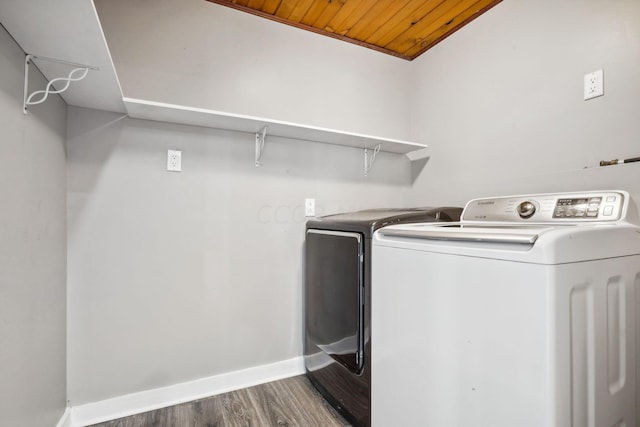 laundry room featuring washing machine and dryer, wood ceiling, and wood-type flooring