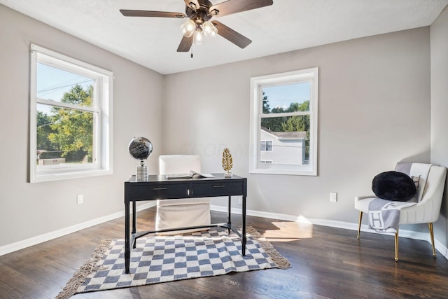 office with dark hardwood / wood-style floors and ceiling fan