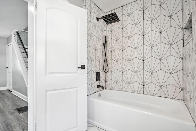 bathroom featuring hardwood / wood-style flooring and tiled shower / bath