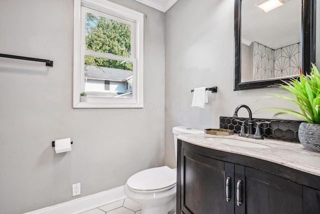 bathroom featuring tile patterned flooring, vanity, toilet, and crown molding