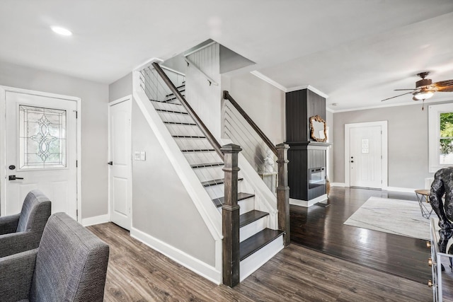 entrance foyer with dark hardwood / wood-style flooring, ceiling fan, and crown molding