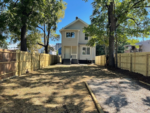 rear view of house featuring central AC