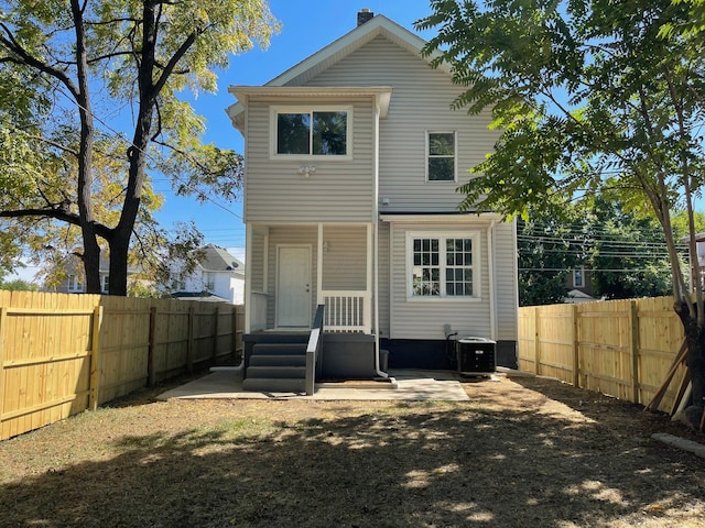 rear view of property with central air condition unit